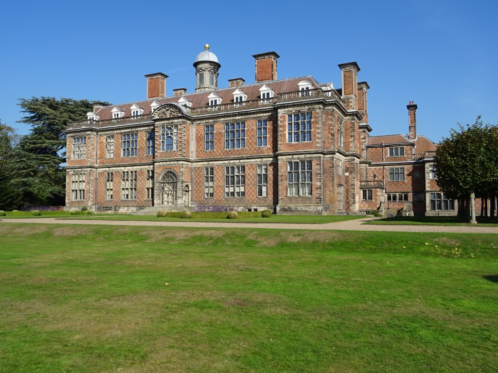 The red brick front of Sudbury Hall across the lawn